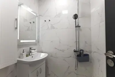 a white bathroom with a shower and a sink at Old Town View in Plovdiv