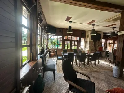 a dining room with a table and chairs and windows at Villa Le Cinema in Shiroki Dol