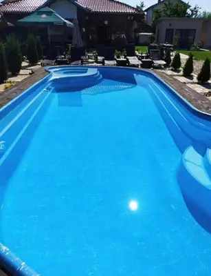 a swimming pool with blue water at Villa Le Cinema in Shiroki Dol