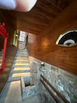 a building with wooden walls and stairs with a bench at Villa Le Cinema in Shiroki Dol