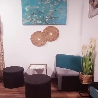 a living room with a chair and two stools at Alis in Sofia