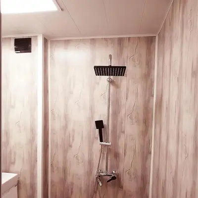 a shower in a bathroom with a wooden wall at Alis in Sofia