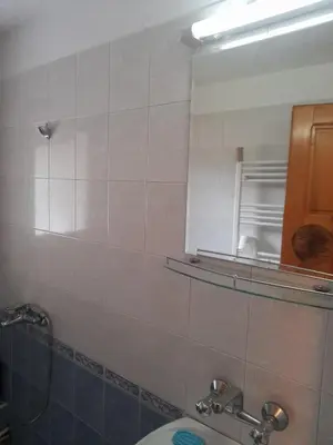 a bathroom with a mirror and a sink at Къща за гости Дани in Govedartsi