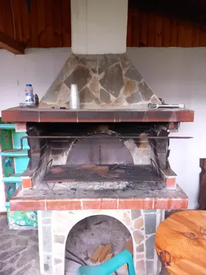 a brick fireplace with a stone oven at Къща за гости Дани in Govedartsi
