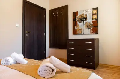 a bedroom with two towels on a bed with a dresser at Апартамент и Студия 