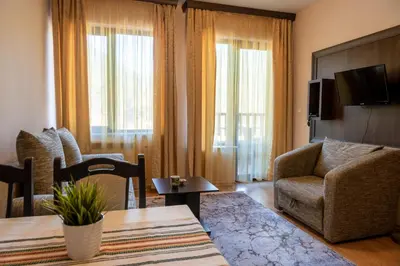 a living room with a couch and a chair and a table at Апартамент и Студия 
