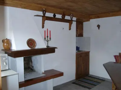 a living room with a fireplace and some candles at Sarafova Guest House in Koprivshtitsa
