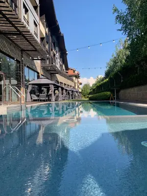 a large pool of water next to a building at The Nature View Suite, part of Terra Complex & Spa in Bansko