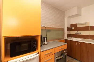 a small kitchen with a microwave and a sink at Charming Artistic Central Apartment in Sofia