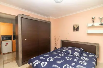 a bedroom with a bed and a large closet at Charming Artistic Central Apartment in Sofia