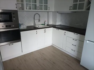 a kitchen with white cabinets and a sink and a microwave at One Bedroom Apartment 61 - Restaurant Stadium Plovdiv in Plovdiv