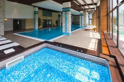 a large swimming pool in a building with a swimming poolvisorvisor at M&R Apartment C13 - SPA Terra Complex in Razlog