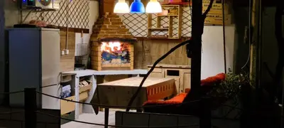 a kitchen with a stove and a fire in it at стаи за гости Никол in Starosel