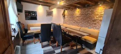 a restaurant with a brick wall and a table and chairs at стаи за гости Никол in Starosel