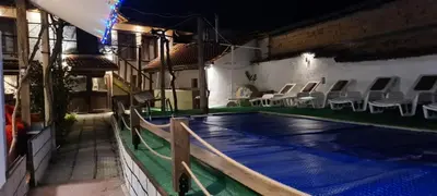 a house with a swimming pool at night at стаи за гости Никол in Starosel