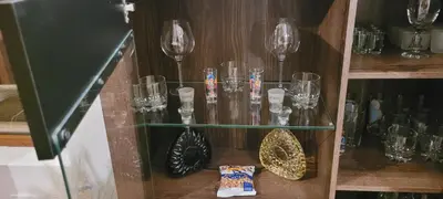 a glass shelf with wine glasses on it at Cozy Rila Park Apartments in Borovets