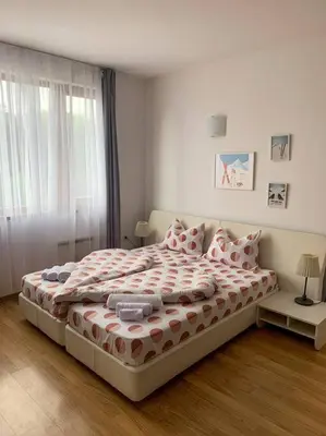 a bedroom with a large bed with pillows on it at Cozy Rila Park Apartments in Borovets