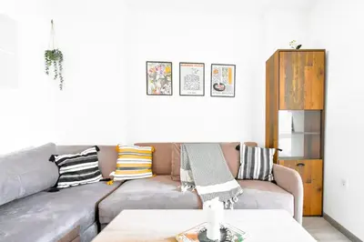 a living room with a gray couch with pillows at Budget Stay Near Sofias Lions Bridge in Sofia