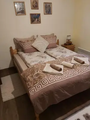 a bed with two towels on it in a bedroom at Къща за гости в селска местност in Petrich