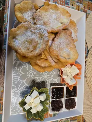 a plate of food with biscuits and other foods at Къща за гости в селска местност in Petrich