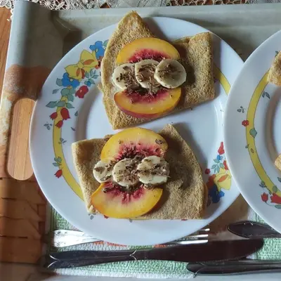 three slices of bread with fruit and mushrooms on a plate at Къща за гости в селска местност in Petrich