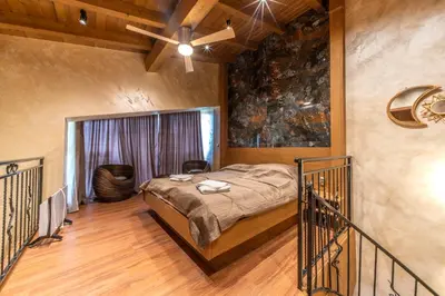 a bedroom with a bed and a ceiling fan at Pirin Golf Hotel&Spa Apartment 42 - private luxury apartment in Razlog