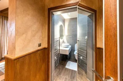 a bathroom with a toilet and a sink at Pirin Golf Hotel&Spa Apartment 42 - private luxury apartment in Razlog