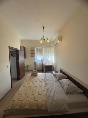 a bedroom with a large bed in a room at Лукс апартамент Базилика отделен вход in Sandanski