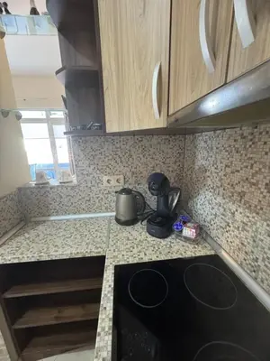 a kitchen with a stove and a counter top at Лукс апартамент Базилика отделен вход in Sandanski