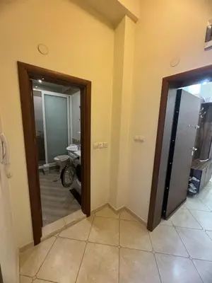 a hallway with a door leading to a bathroom at Лукс апартамент Базилика отделен вход in Sandanski