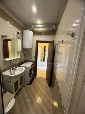 a bathroom with a shower and a toilet and a sink at Лукс апартамент Базилика отделен вход in Sandanski