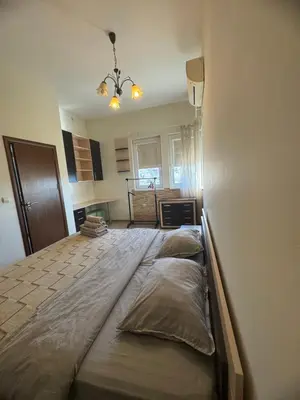 a bedroom with a large bed with pillows on it at Лукс апартамент Базилика отделен вход in Sandanski