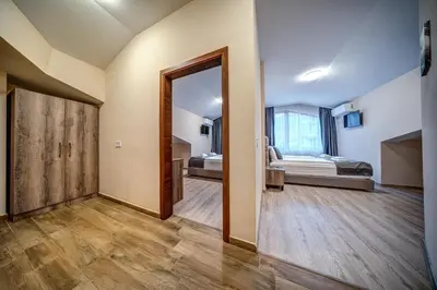 a room with a bed and a door leading to a bedroom at VALEMO Apart House in Devin