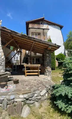 a house with a bench in front of it at КЪЩА ЗА ГОСТИ ВОДЕНИЦАТА in Devin