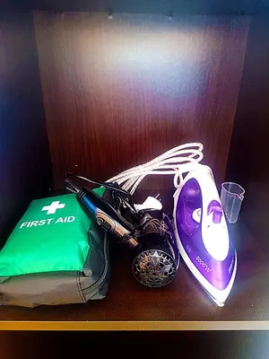 a wooden shelf with a first aid kit and a helmet at 