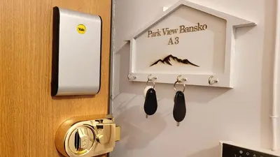 a door with a pair of shoes hanging from it at Spacious stylish studio with large terrace and amazing view, 5 min to Gondola & Bar Str in Bansko