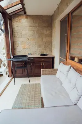 a living room with a couch and a piano at Spacious stylish studio with large terrace and amazing view, 5 min to Gondola & Bar Str in Bansko