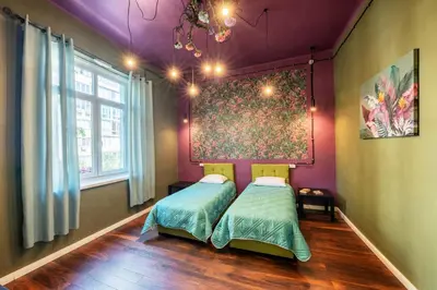 a bedroom with a bed and a painting on the wall at The Green Bar House in Sofia