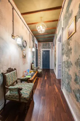 a hallway with chairs and a table and a chandelier at The Green Bar House in Sofia