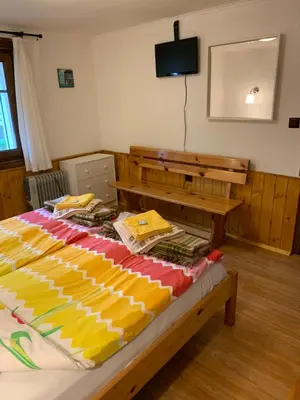 a bedroom with a bed and a desk and a television at Borimechkova Kashta in Koprivshtitsa
