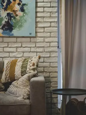 a dog sitting on a couch in a living room at Stylish 1BD - Free Private Garage in Plovdiv