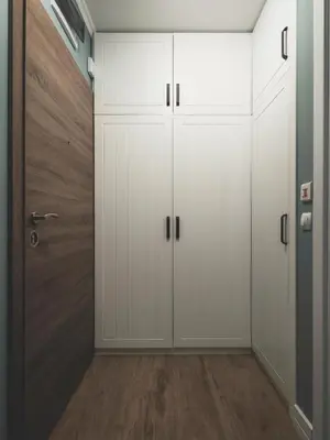 a closet with white cabinets and a door at Stylish 1BD - Free Private Garage in Plovdiv