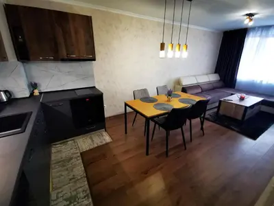 a kitchen and living room with a table and chairs at Viva 3 Grand monastery in Pamporovo