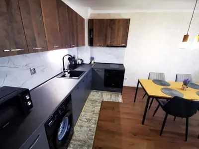 a kitchen with a table and a sink and a dishwasher at Viva 3 Grand monastery in Pamporovo