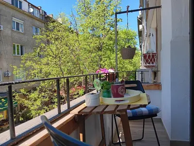 a balcony with a table and chairs on a balcony at Bijoux Apt in the heart of Sofia in Sofia