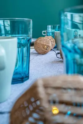 a table topped with blue glasses and a basket at City Oasis: Stylish Retreat in the Heart of Sofia in Sofia