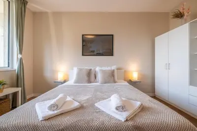 a bedroom with a bed with towels on it at City Oasis: Stylish Retreat in the Heart of Sofia in Sofia