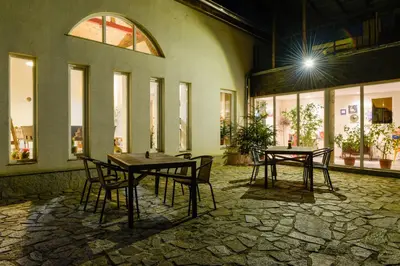 a patio with tables and chairs in a building at Villa 