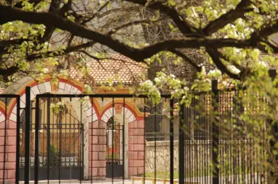 a fence in front of a pink brick building at Villa 