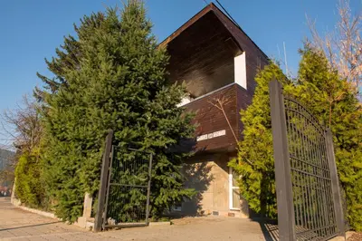 a building with a gate and two trees at Villa 
